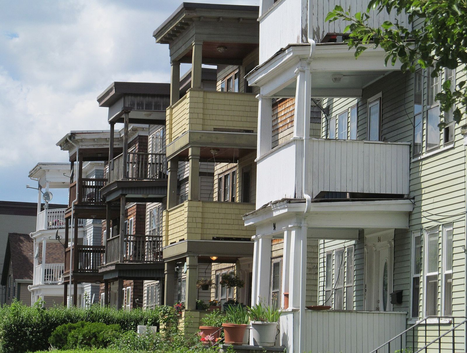 Triple-decker homes with front porches in Dorchester, Boston